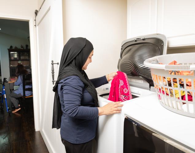 Caregiver doing laundry.