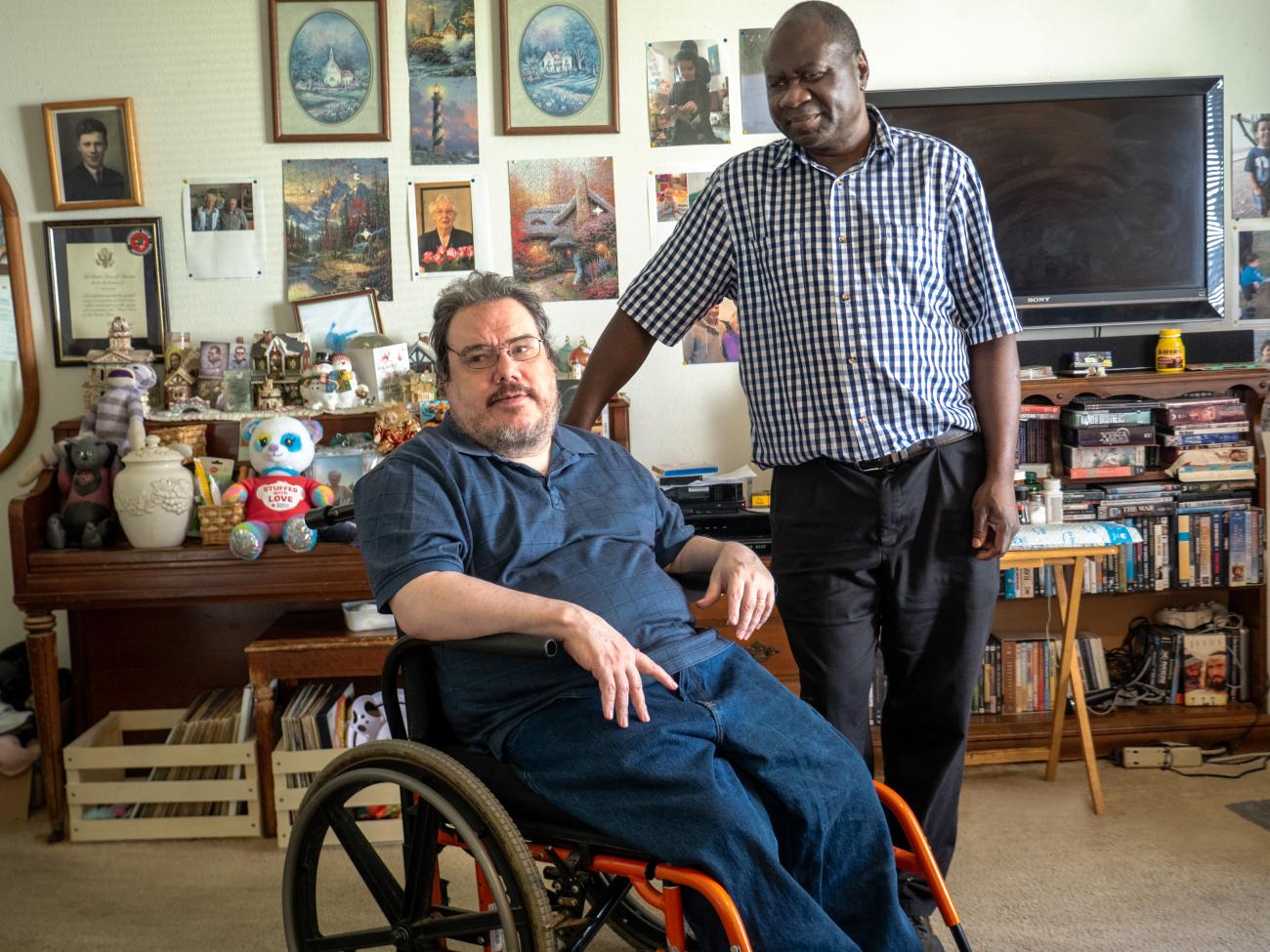 Caregiver standing next to client in their home.