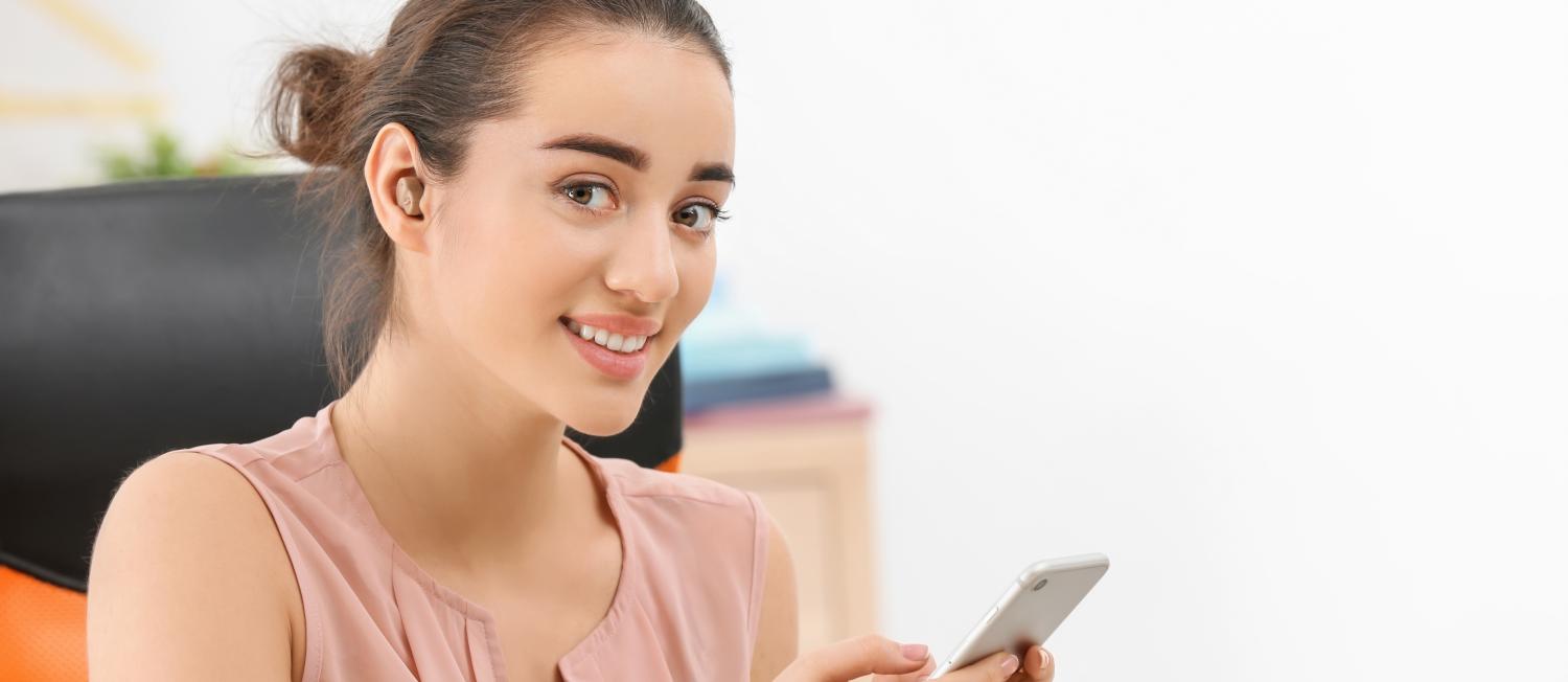 Woman sitting in a chair on her smartphone.